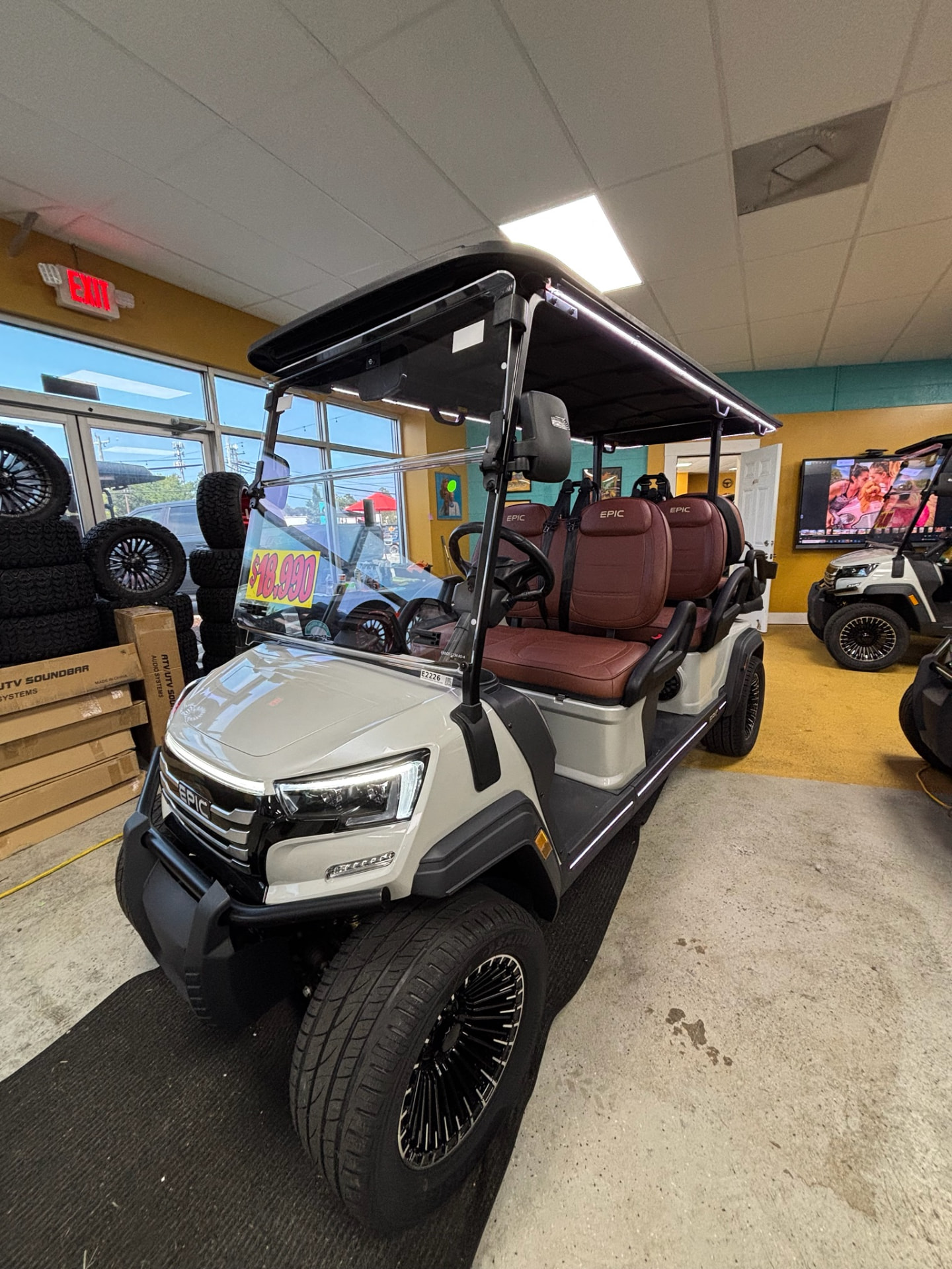 2026 Epic FX60 white six-passenger street legal cart with burgundy leather seats on the Moke Virginia Beach showroom floor